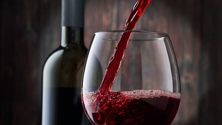 red wine being poured into a glass