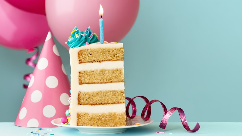 a slice of birthday cake with a candle