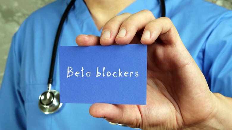 Doctor holding card with the words beta blockers written on it