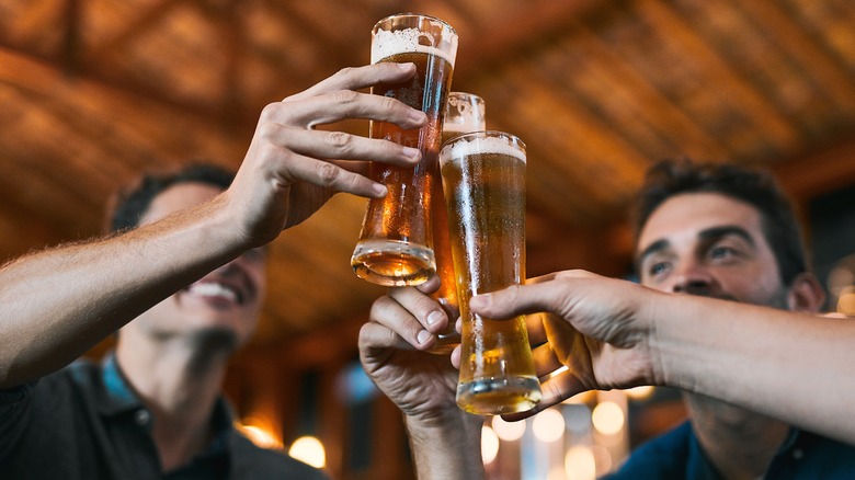 Men at a bar drinking beer together