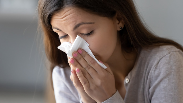 woman blowing her nose