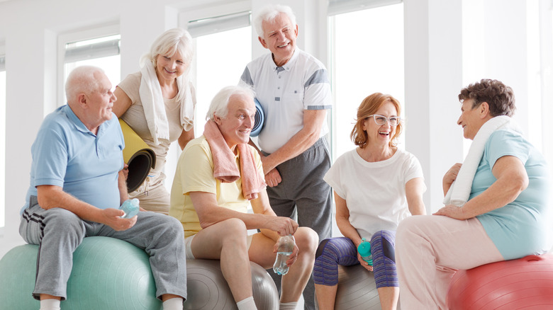 group of elderly people socializing after exercise