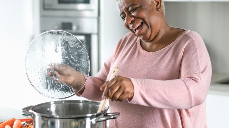 smiling woman cooking a meal