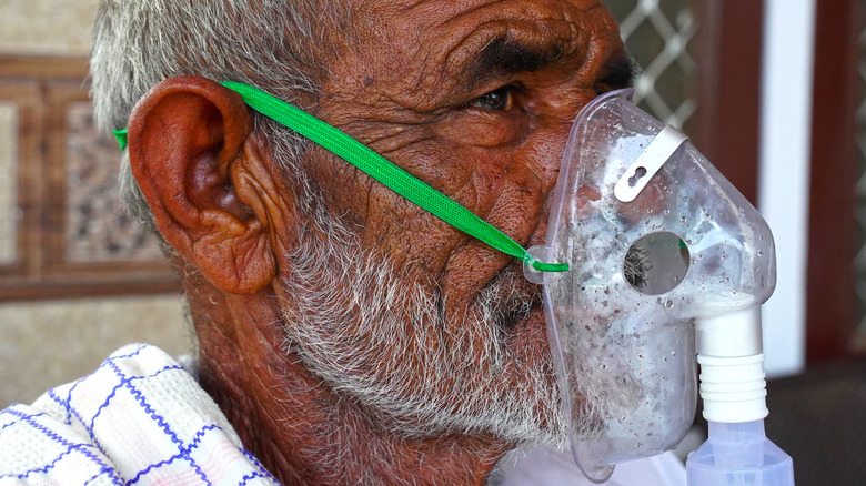 elderly male wearing nebulizer mask