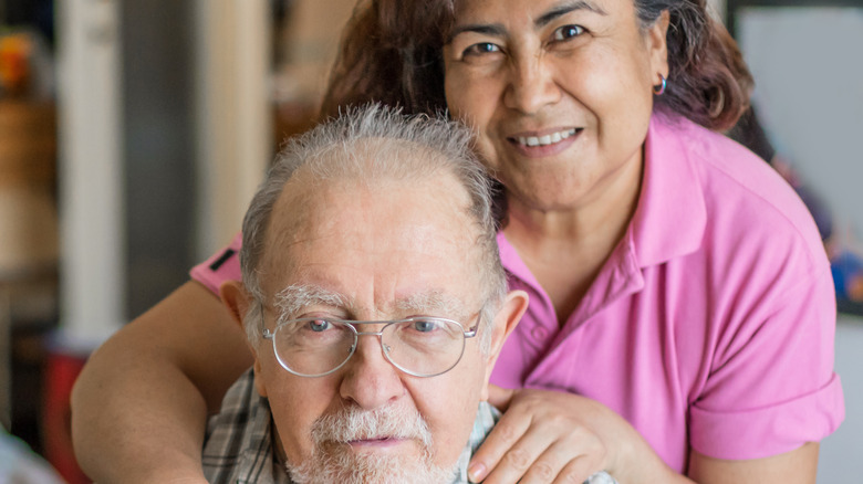 senior man with caregiver at home