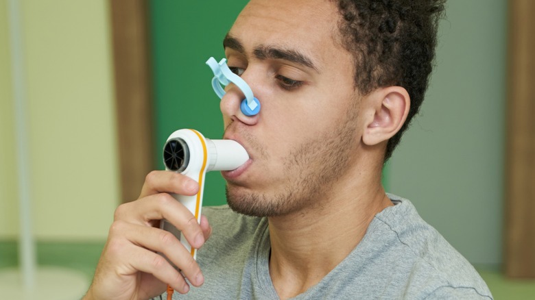 man holding spirometer during test