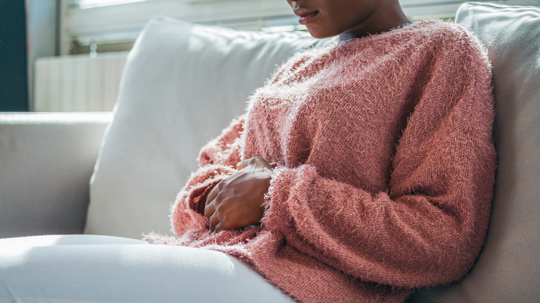 woman on the couch with cramps