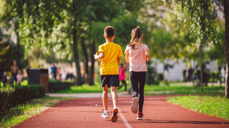 Two children running on track