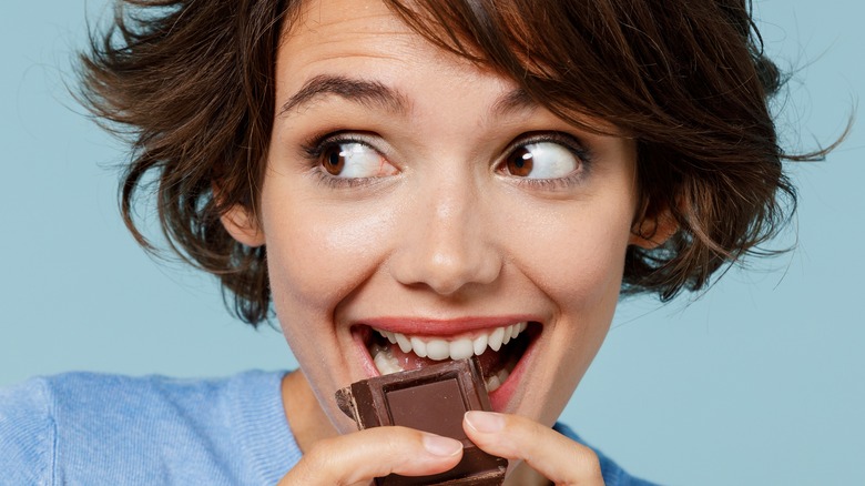 woman sneaking a piece of chocolate