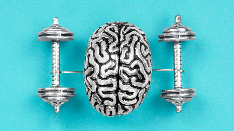 A brain connected to dumbbells
