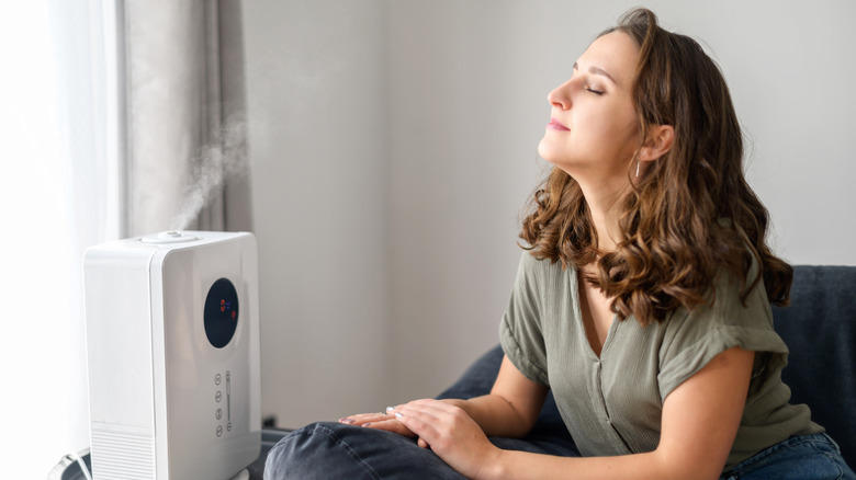 Someone breathes in air from a humidifier