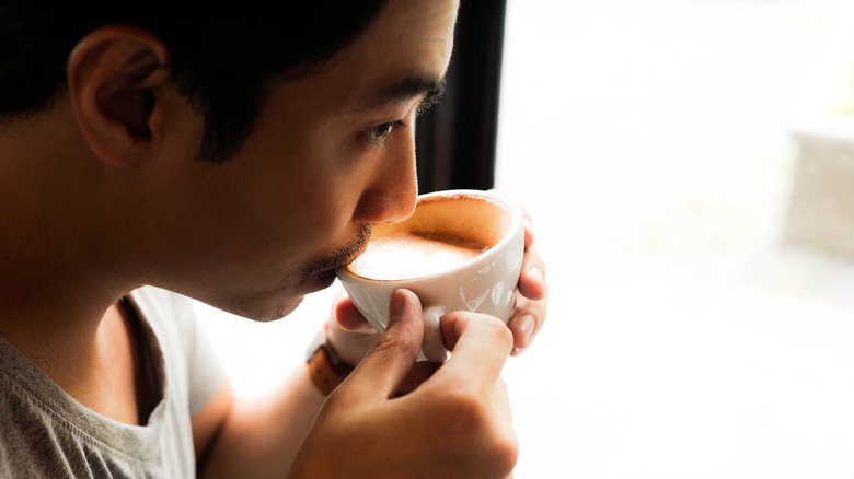 Man sipping cup of coffee