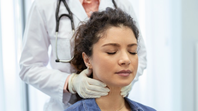 woman getting thyroid checked