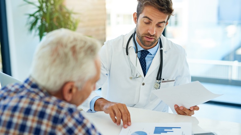 doctor consulting with older man