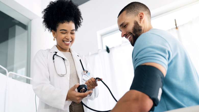 man having blood pressure check by doctor