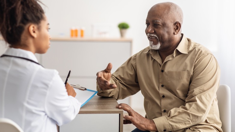 older man talking with doctor