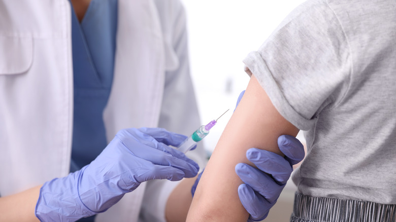 Nurse giving kid a vaccine