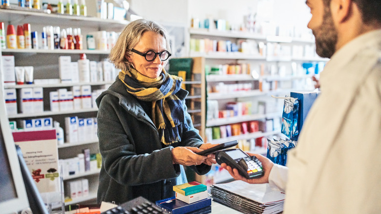 Woman paying at pharmacy