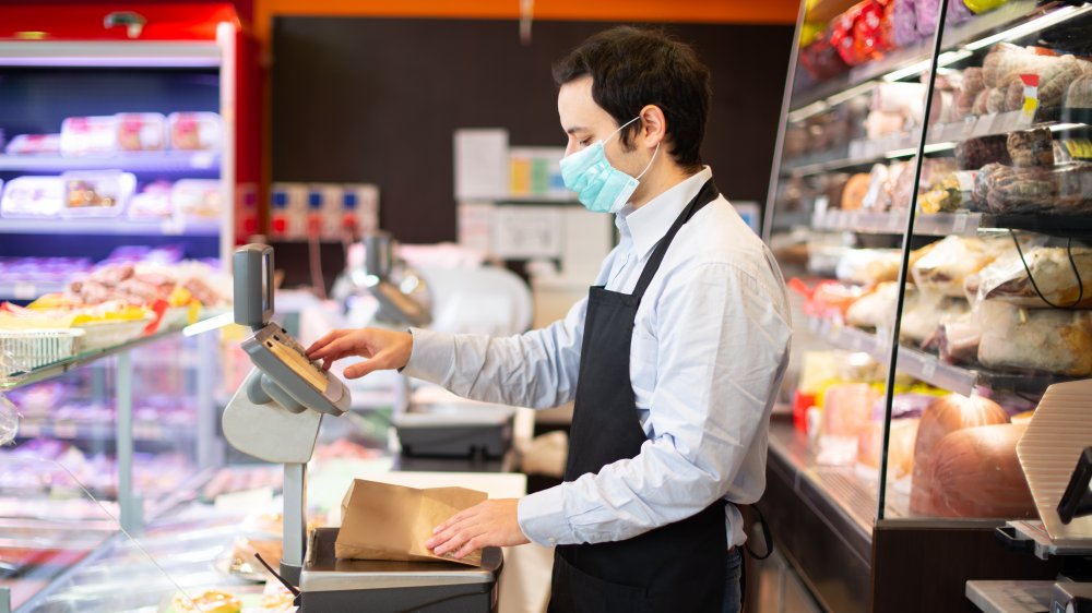 Man works at a deli counter