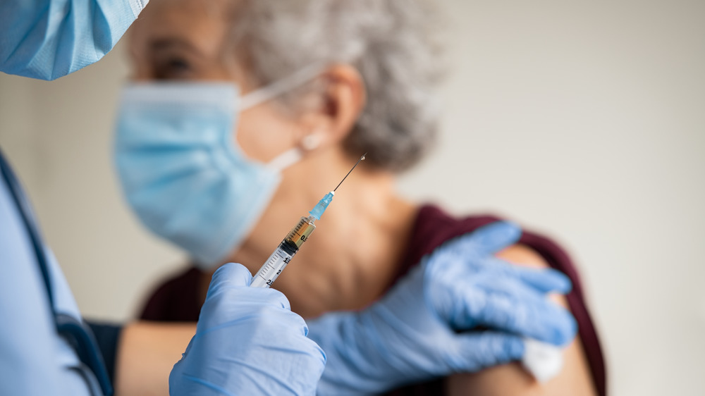Elderly woman receiving COVID vaccine