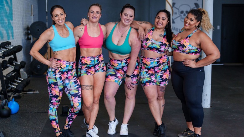 Kelsea Hellyar posing in the gym with group of women