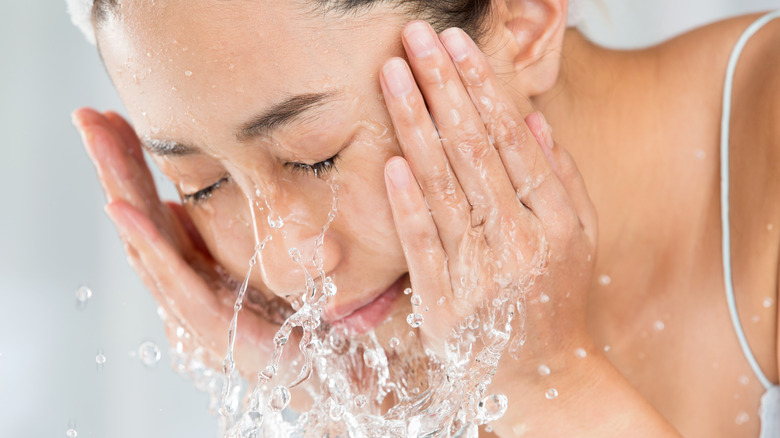 Asian woman washing face 