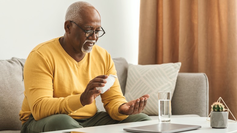 Man holding pill bottle