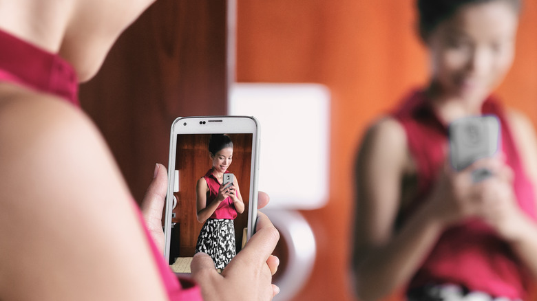 woman taking a mirror selfie