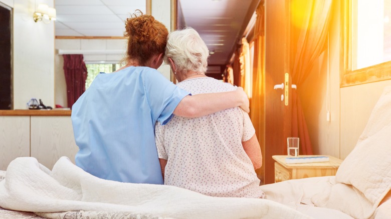 healthcare worker with her arm around hospice patient