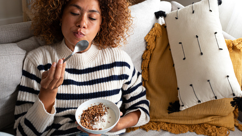 woman eating bowl of cereal