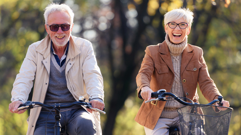 active elderly couple on bikes