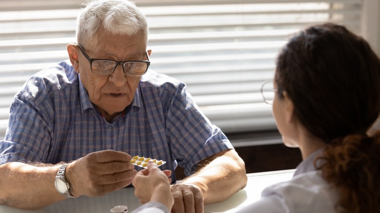 elderly man taking medication