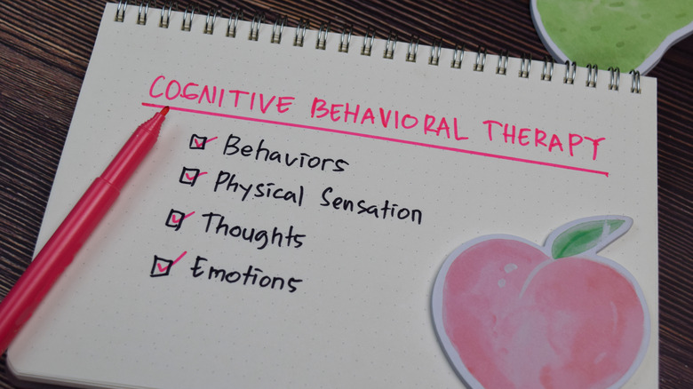 notepad with cognitive behavioral therapy checklist