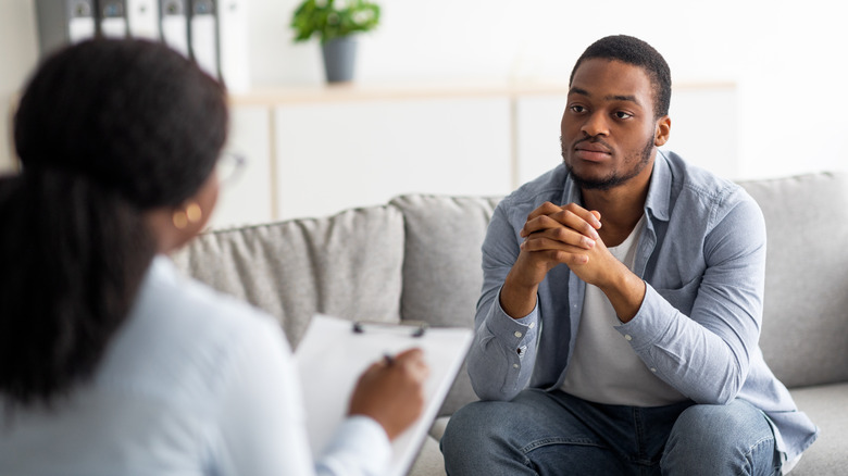 man attending therapy session with psychiatrist