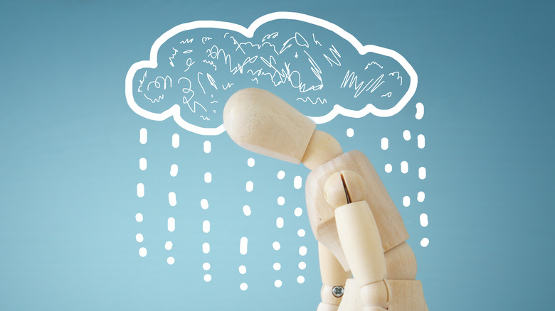 illustrated cloud raining on wooden model
