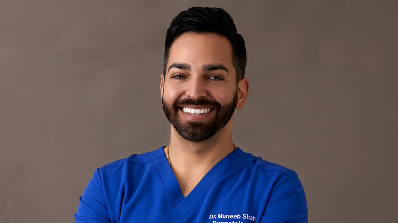 Dr. Shah smiling wearing his personalized scrubs