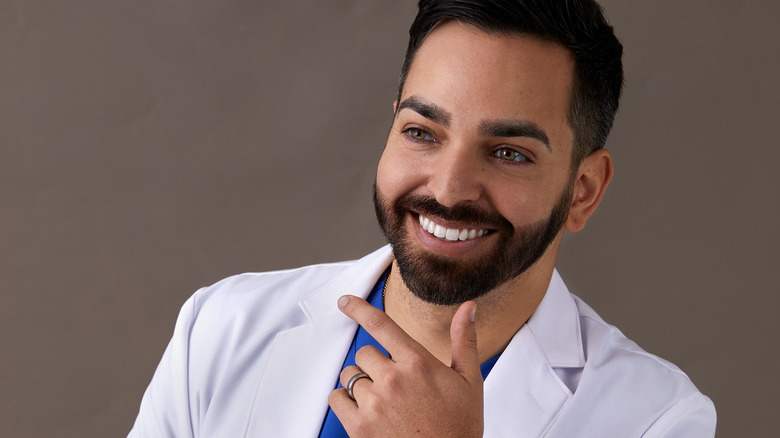 Dr. Shah with a big smile and his hand under his chin