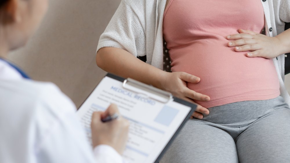 pregnant woman talking to doctor