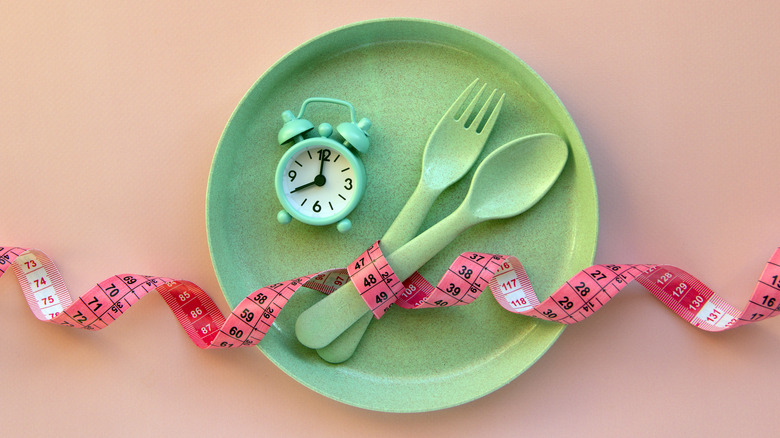 Green plate, utensils and clock with tape measure