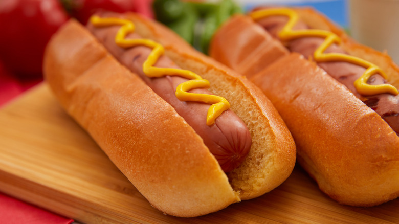 hot dogs covered in mustard