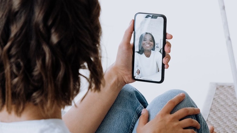 Woman talking to her Newtopia health coach on a smartphone