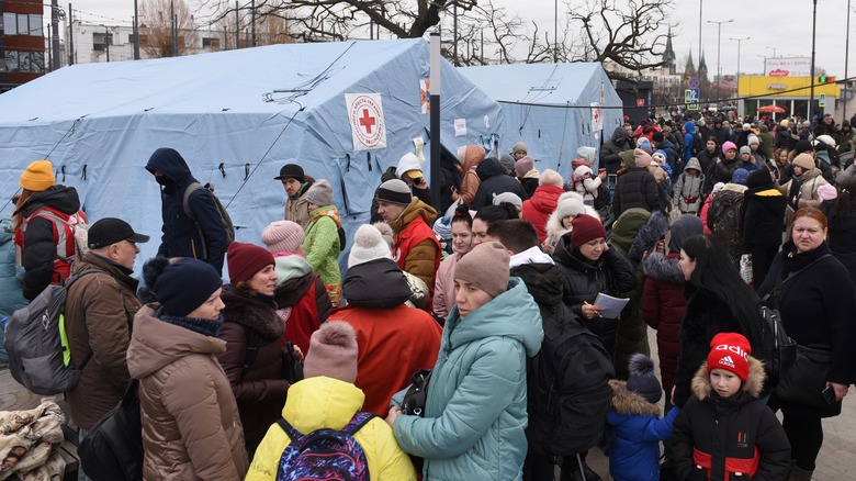 Ukrainians gathered outside of Red Cross tent