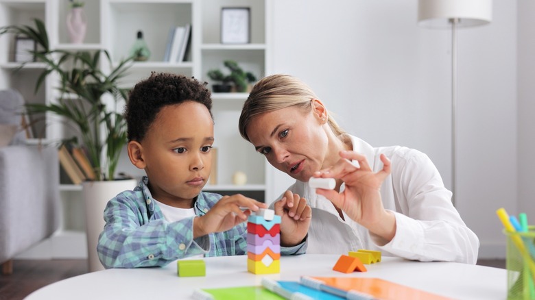 Female doctor evaluating little boy