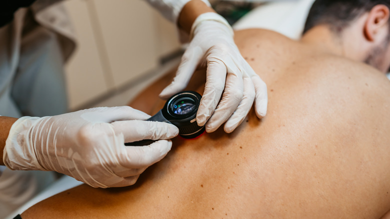 Doctor evaluating patient's back