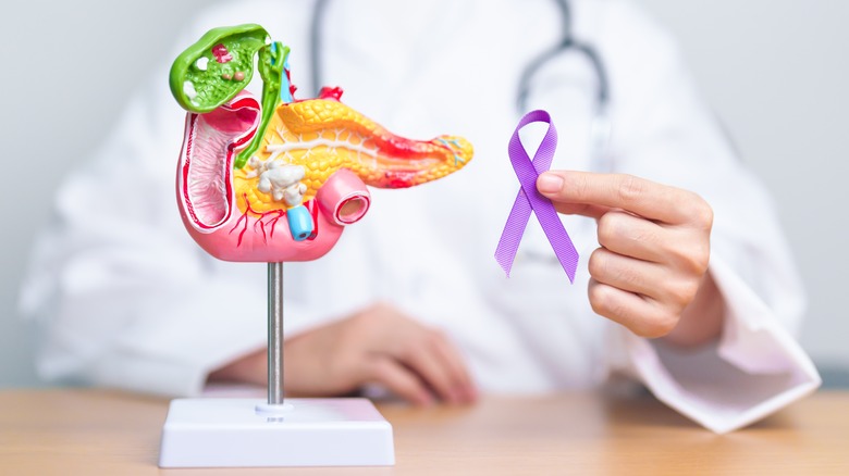 Doctor holding pancreatic cancer ribbon