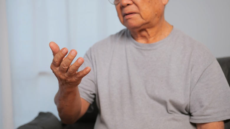 Older man with trembling hand