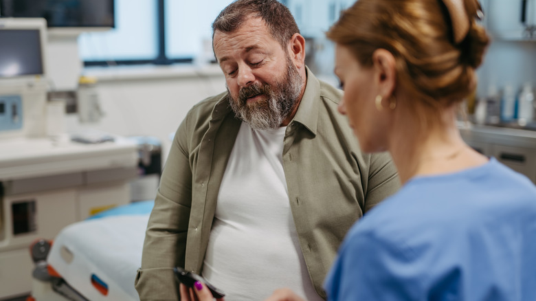 Nurse checking patient's blood sugar