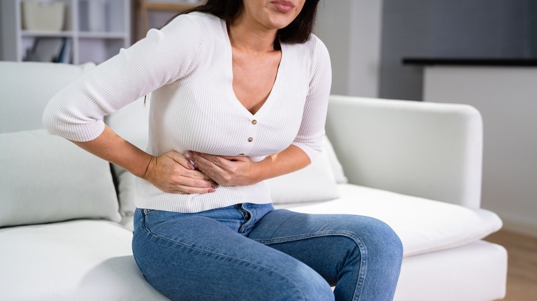 woman holding stomach