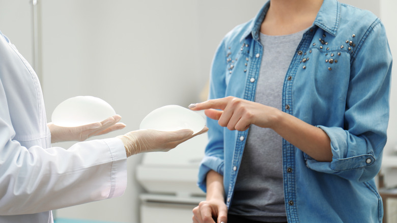 Woman choosing a breast implant