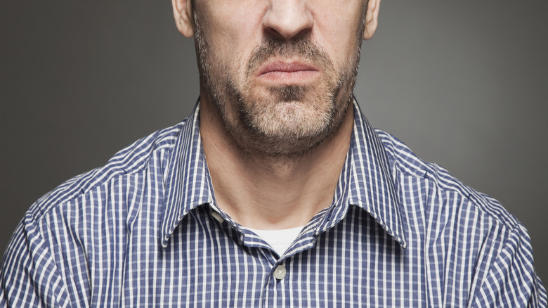 A man noticing a smelly odor